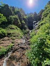 Mountain river and waterfall in green forest in summer. Vertical photo. Arkhyz, Karachay-Cherkessia, mountains of the North Royalty Free Stock Photo