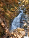 Mountain river with a waterfall among stones and autumn forest Royalty Free Stock Photo
