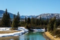 Mountain river with wooden bridge in early spring eastern british columbia canada