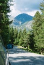 Mountain road in the Alps. Car parked by the road. Brusson, Italy
