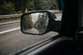 mountain road in autumn in the rain in the car mirror Royalty Free Stock Photo