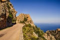 Mountain road with big cliffs overlooking the ocean on Corsica Royalty Free Stock Photo