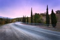 Mountain road with blurred cars in motion at sunset Royalty Free Stock Photo