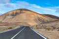 Mountain road on colourful remote basal hills and mountains of Massif of Betancuria, Fuerteventura, Canary islands, Spain Royalty Free Stock Photo