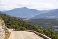 Mountain road curve above the forest and agricultural fields in French countryside Royalty Free Stock Photo