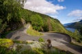 Mountain road in in Dalen, Norway with lake Bandak in the backgorund on a sunny day Royalty Free Stock Photo
