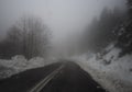 Mountain road, fog, clouds and snow in the forest in the mountains Dirfis on the island of Evia, Greece Royalty Free Stock Photo