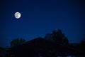 Mountain Road through the forest on a full moon night. Scenic night landscape of dark blue sky with moon. Azerbaijan Royalty Free Stock Photo