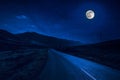 Mountain Road through the forest on a full moon night. Scenic night landscape of dark blue sky with moon. Azerbaijan Royalty Free Stock Photo