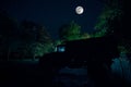 Mountain Road through the forest on a full moon night. Scenic night landscape of dark blue sky with moon. Azerbaijan. Long shutter Royalty Free Stock Photo