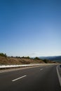 Mountain road. Landscape with rocks, sunny sky with clouds and beautiful asphalt road in the evening in summer. Vintage Royalty Free Stock Photo