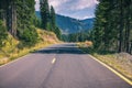 Mountain road. Landscape with rocks, sunny sky with clouds and beautiful asphalt road in the evening in summer. Vintage toning. Royalty Free Stock Photo