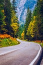 Mountain road. Landscape with rocks, sunny sky with clouds and beautiful asphalt road in the evening in summer. Vintage toning. Royalty Free Stock Photo