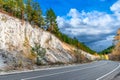 Mountain road. Landscape with rocks, sunny sky with clouds and beautiful asphalt road in evening in autumn or summer Royalty Free Stock Photo