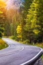 Mountain road. Landscape with rocks, sunny sky with clouds and beautiful asphalt road in the evening in summer. Vintage toning. Royalty Free Stock Photo