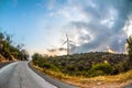 Wind farm on mountain road sunset