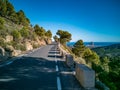 Mountain road with protection bollards near ifach boulder Royalty Free Stock Photo