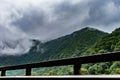 Mountain road railing with foggy mountain forest in the background