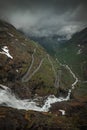 Mountain road Trollstigen winding through landscape with waterfall and valley of Trollveggen in Norway Royalty Free Stock Photo