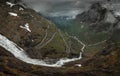 Mountain road Trollstigen winding through landscape with waterfall and valley of Trollveggen in Norway Royalty Free Stock Photo