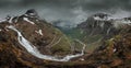 Mountain road Trollstigen winding through landscape with waterfall and valley of Trollveggen in Norway Royalty Free Stock Photo