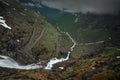 Mountain road Trollstigen winding through landscape with waterfall and valley of Trollveggen in Norway Royalty Free Stock Photo