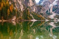 Mountain rocks and autumn forest reflected in water of Braies Lake, Dolomite Alps, Italy Royalty Free Stock Photo