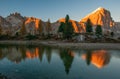 Mountain rocks and autumn trees reflected in water of Limides Lake at sunset, Dolomite Alps, Italy Royalty Free Stock Photo