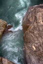 Mountain rough river merges into abyss between huge boulders Royalty Free Stock Photo