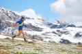 Mountain runner with chopsticks in downhill training