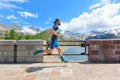 Mountain runner passes over an alpine dam