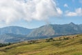 Mountain and savannah field with low cloud over hill. Rinjani mountain, Lombok island, Indonesia Royalty Free Stock Photo