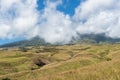 Mountain and savannah field with low cloud over hill. Rinjani mountain. Royalty Free Stock Photo