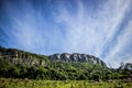 Mountain scape with thin clouds in a blue sky Royalty Free Stock Photo
