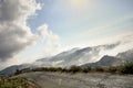 Mountain scenery clouds beneath you small rock stone and asphalt old road. Lebanon, Jbeil.