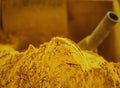 Mountain of scented golden tumeric spice powder displayed at a local farmers market in Sicily