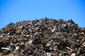 Mountain of scrap metal, against a blue background Royalty Free Stock Photo