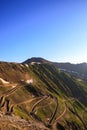 Mountain serpentine in the alps. view of the free road in the forest among the rocks Royalty Free Stock Photo