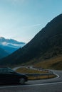 Vertical landscape carpathians mountains and cars on serpentine road, on background of sunset sky.