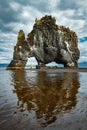 Mountain in the shape of a rhinoceros with tourist woman. Iceland