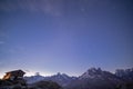 Mountain Shelter at Dawn with Snowy Peaks under Blue Starry Sky Royalty Free Stock Photo