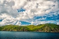 Mountain shore in blue sea on cloudy sky in gustavia, st.barts. Summer vacation on tropical island. Wild nature and