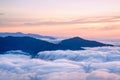 Mountain silhouette above the clouds at sunrise, view from the t Royalty Free Stock Photo