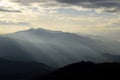 Mountain silhouettes with sunbeams