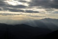 Mountain silhouettes with sunbeams