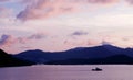 Mountain, sky, boat on sea at sunset Royalty Free Stock Photo