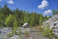 Mountain slope with large stones against a blue summer sky with white cumulus clouds Royalty Free Stock Photo