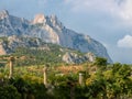 Mountain slope overgrown with trees, steep rocks at the top Royalty Free Stock Photo