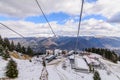 Mountain slopes with chairlift on a winter sunny day. Winter mountains panorama with ski slopes and ski lifts near ski center.. Royalty Free Stock Photo