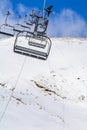 Mountain slopes with chairlift on a winter sunny day Winter mountains panorama with ski slopes and ski lifts near Brasov ski cent Royalty Free Stock Photo